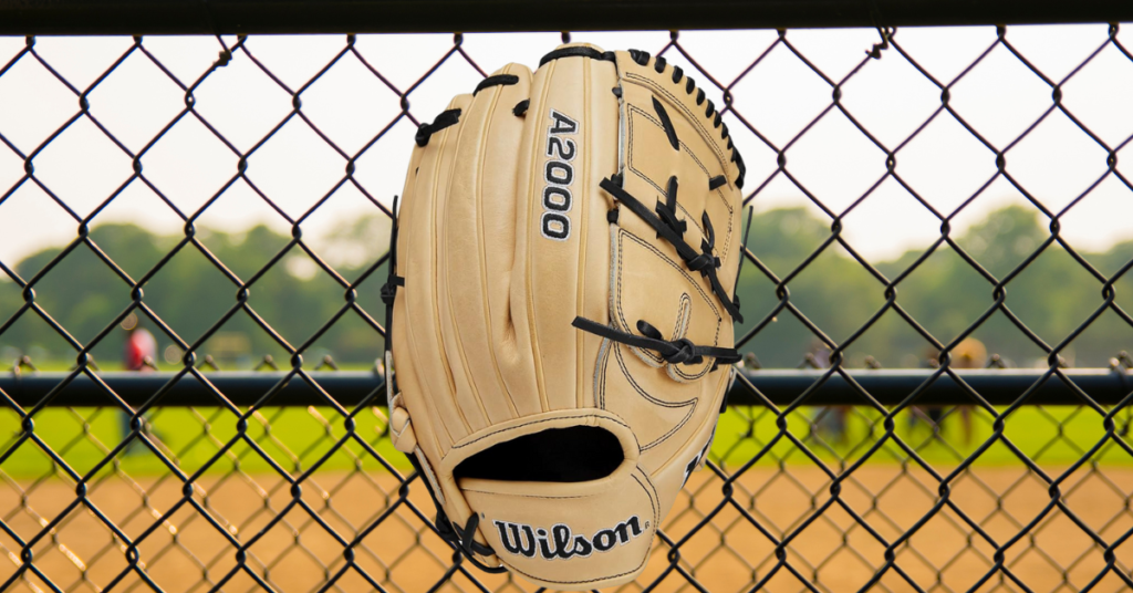 A 2000 Pitchers Glove against a fence